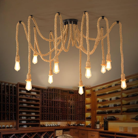 Lit above a room with wine shelving, a wood table and chairs below
