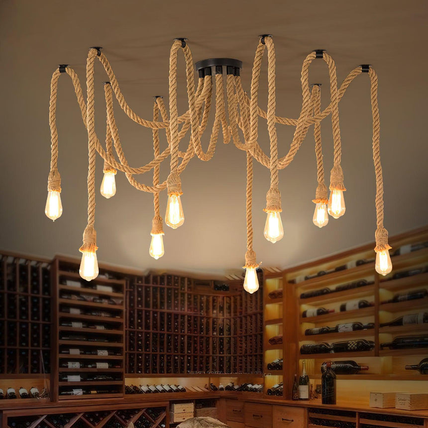 Lit above a room with wine shelving, a wood table and chairs below