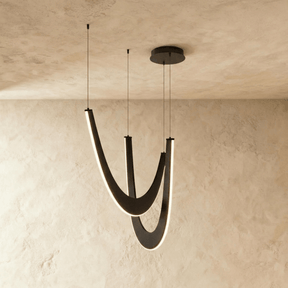 Two nested black wood arcs hung on cables, each lit along its inner edge