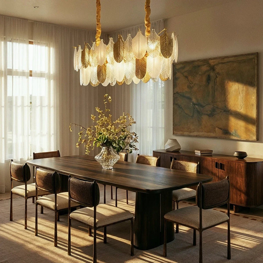 The round version lit above a long dining table with chairs and a sideboard