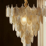 The shades layered in tiers, each one ribbed along its length like a feather