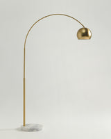 The same arc in brass, the dome shade held high over the marble base