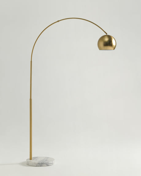 The same arc in brass, the dome shade held high over the marble base