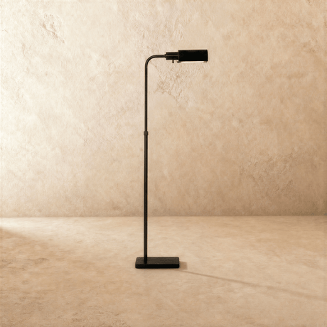 The same lamp in black, the flat head tipped forward above a small square base
