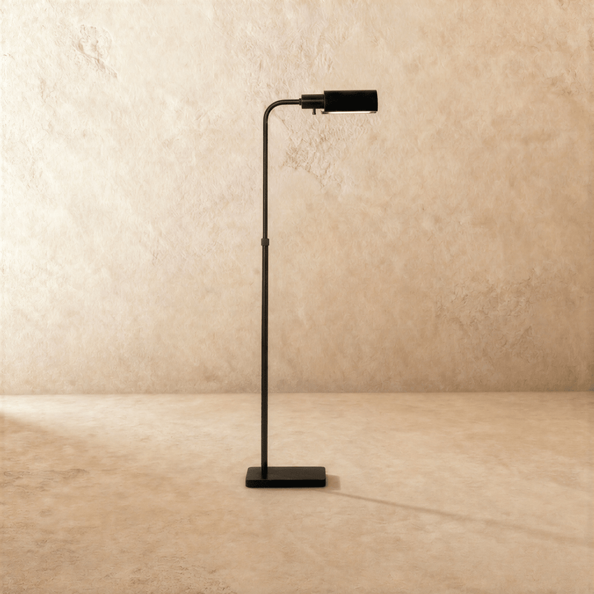 The same lamp in black, the flat head tipped forward above a small square base