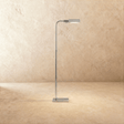 A slim polished chrome stem with a flat rectangular head tipped forward over a small base