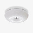 Swirled glass flush mount ceiling light with a chrome center cap
