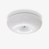 Swirled glass flush mount ceiling light with a chrome center cap
