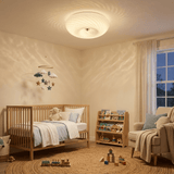 Swirled glass ceiling light above a crib in a nursery with wood toys