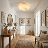 Swirled glass ceiling light in a hallway with an arched mirror and a console