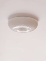 Unlit swirled glass ceiling light seen from the side