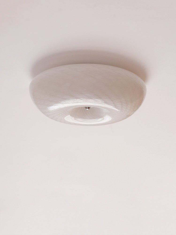 Unlit swirled glass ceiling light seen from the side