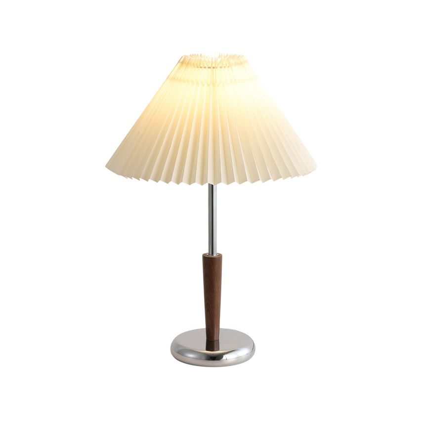 Chrome table lamp seen in full against a plain background, shade and foot