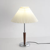 Chrome table lamp lit and seen at a three quarter angle