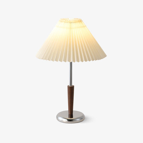Chrome table lamp with a white pleated shade and a walnut stem, plain background