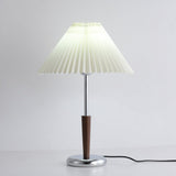 Chrome table lamp showing the pleated shade above the slim stem