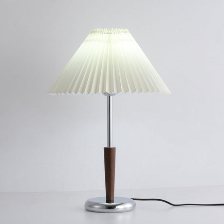 Chrome table lamp showing the pleated shade above the slim stem