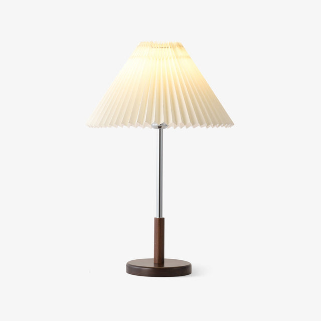 Chrome stem table lamp with a pleated cream shade on a walnut disc base