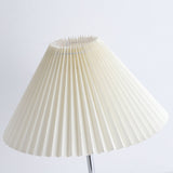 Close view of the pleated cream shade and its folded upper edge