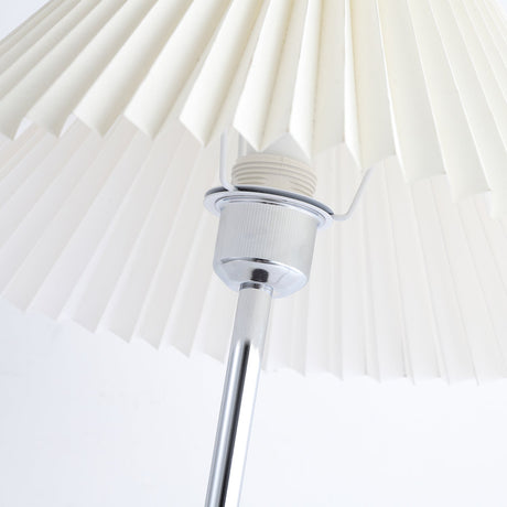 Close view of the socket and shade fitting under the pleated shade