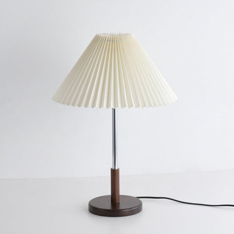 Chrome stem table lamp unlit seen from a slight angle with its cord