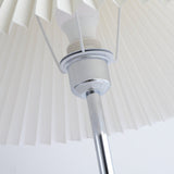 Close view of the socket and the chrome fitting inside the pleated shade