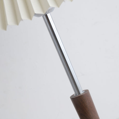 Close view of the chrome stem and the turned walnut section set into it