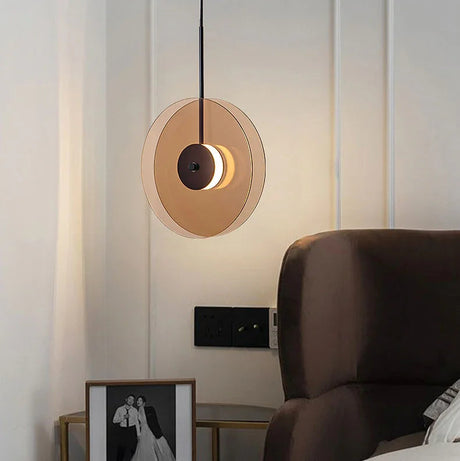 The glass disc hung upright beside an armchair and framed artwork