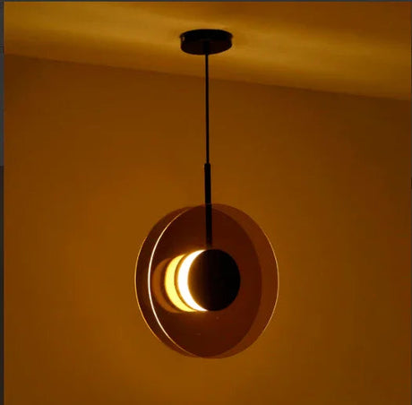 The disc hung upright against a warm lit wall showing its lit edge