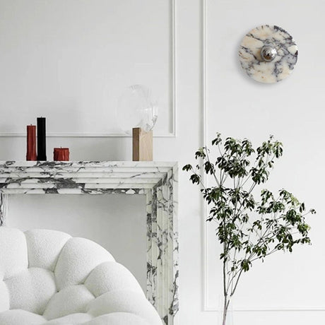 The marble disc above a marble fireplace and a white armchair