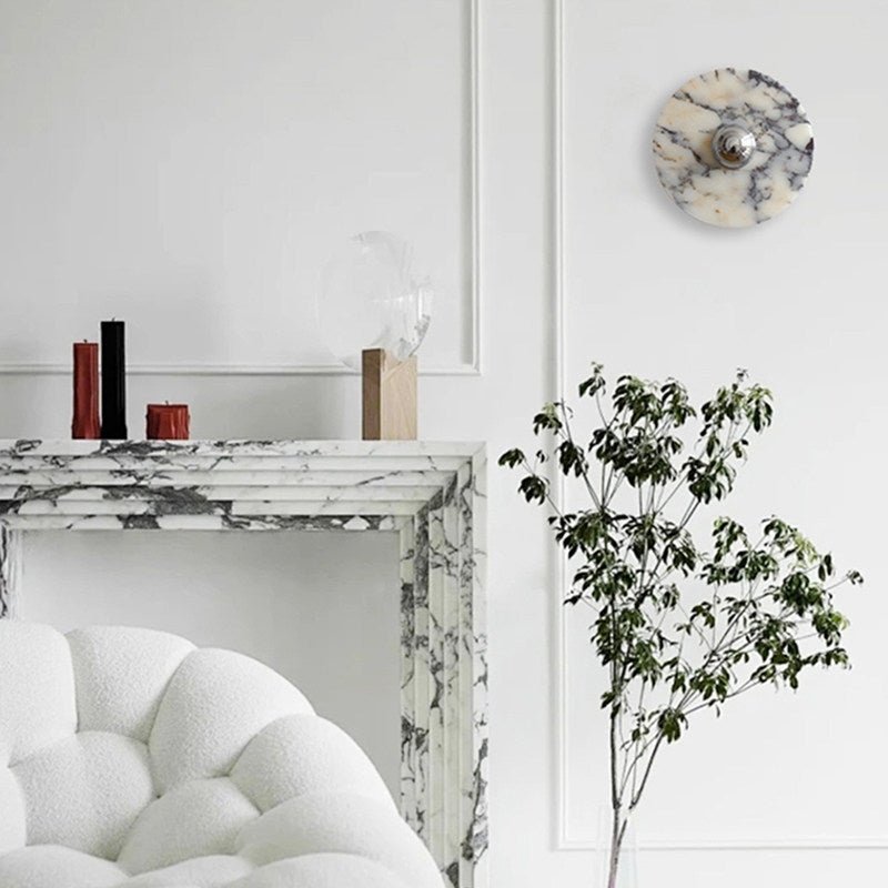 The marble disc above a marble fireplace and a white armchair