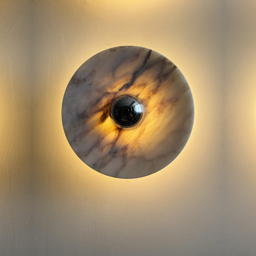 The marble disc lit, warm light glowing around its edge