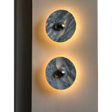 Two lit discs showing the gray veining of the marble