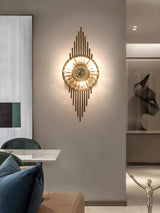 The sconce lit on a gray wall above a sofa with a blue cushion