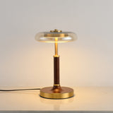 Close view of the round brass foot under the walnut column
