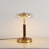 Front view of the glass disc lamp on its round brass foot