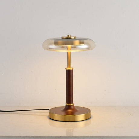 Front view of the glass disc lamp on its round brass foot