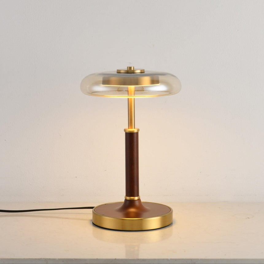 Front view of the glass disc lamp on its round brass foot