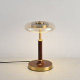 Close view of the lit glass disc above the brass collar and stem