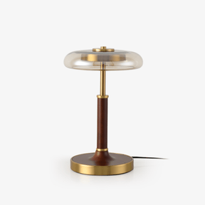 Table lamp with a clear glass disc shade on a walnut column and brass