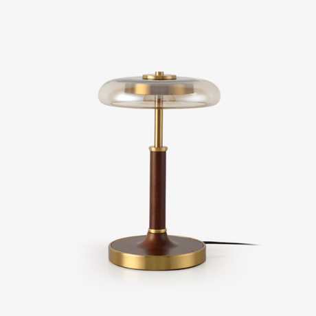 Table lamp with a clear glass disc shade on a walnut column and brass