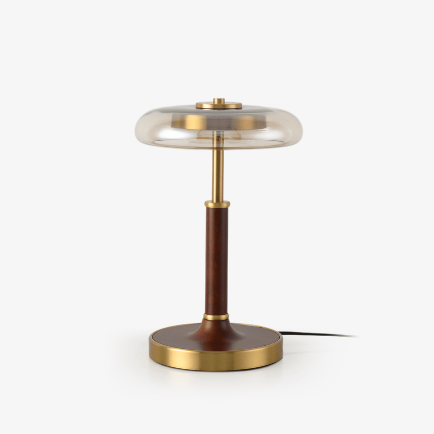 Table lamp with a clear glass disc shade on a walnut column and brass