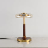 Side view of the glass disc lamp showing the thin walnut column