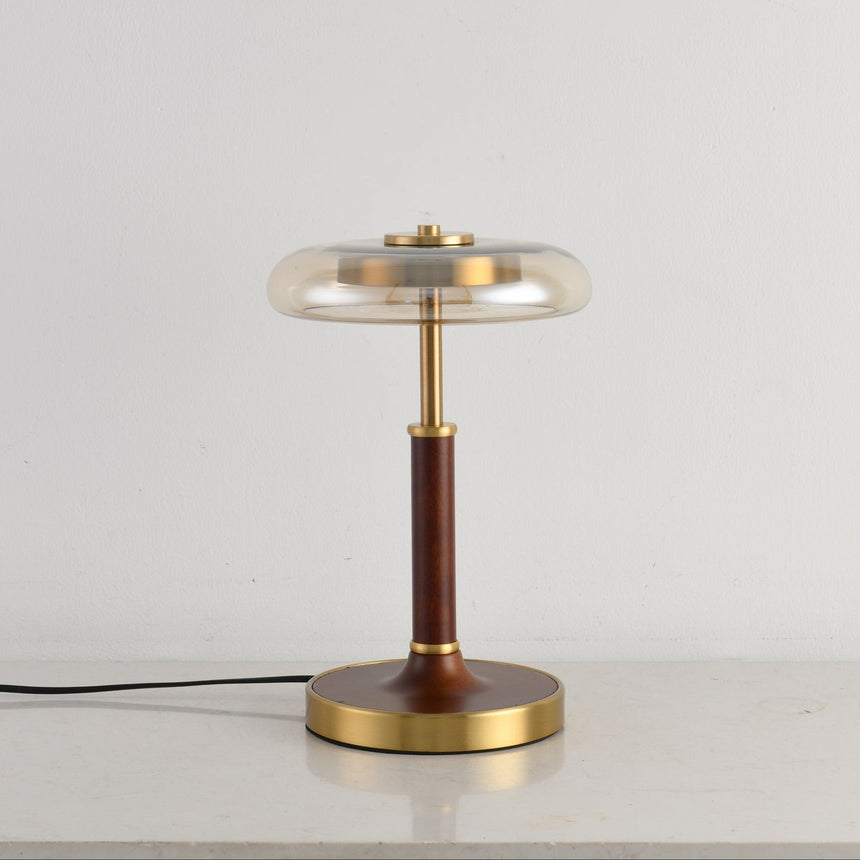 Side view of the glass disc lamp showing the thin walnut column