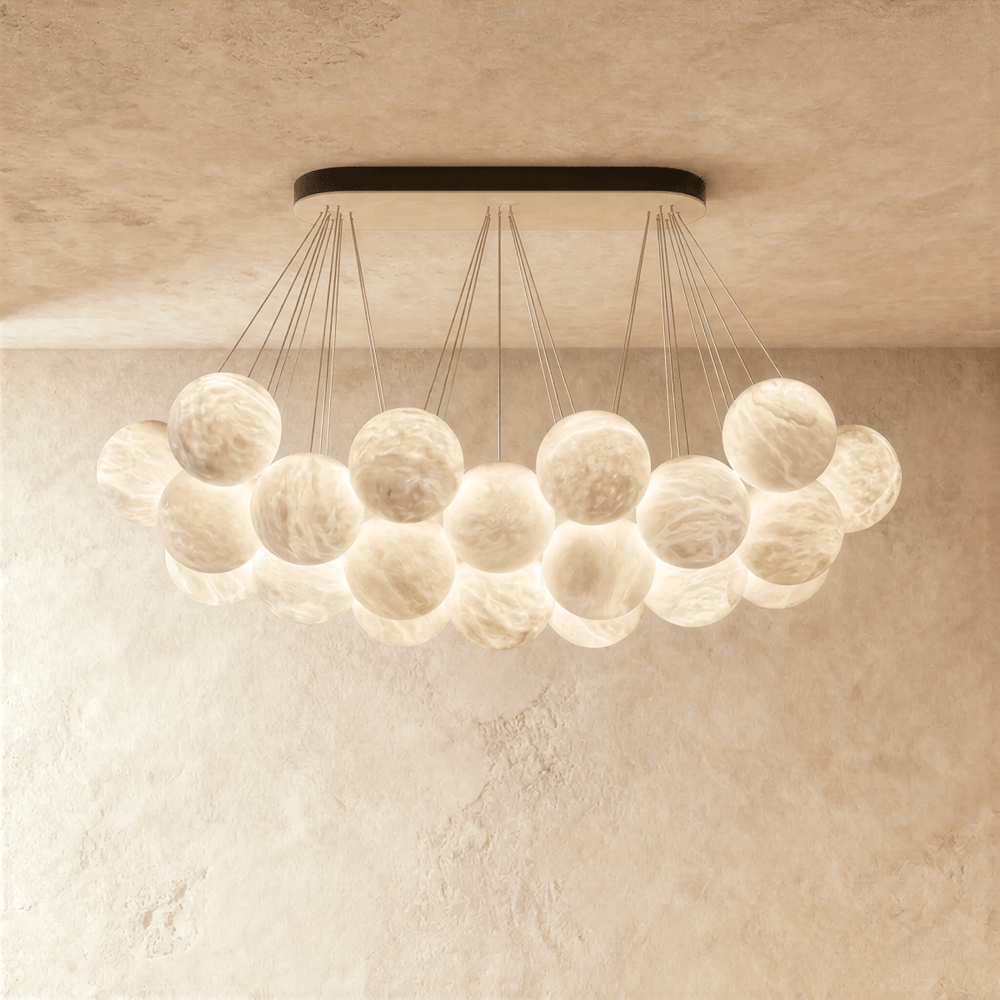 A raft of alabaster globes lit below a black canopy bar on thin cables
