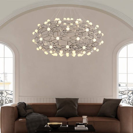 The lit cloud above a brown sofa and coffee table below a tall arched window