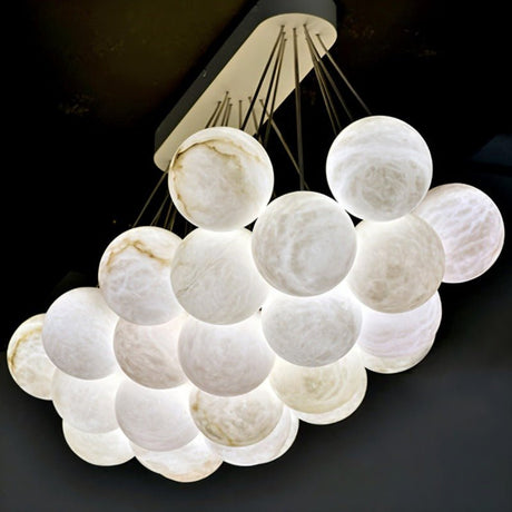 The same raft of globes lit and viewed at an angle, brass canopy above