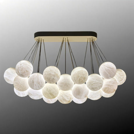 The raft of lit globes with the canopy bar in black and brass above it