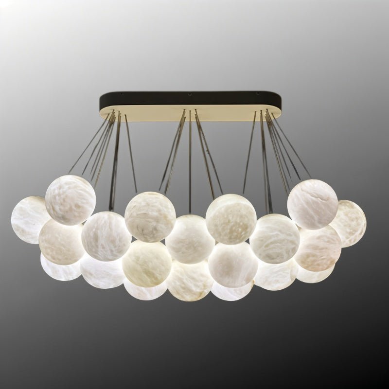 The raft of lit globes with the canopy bar in black and brass above it