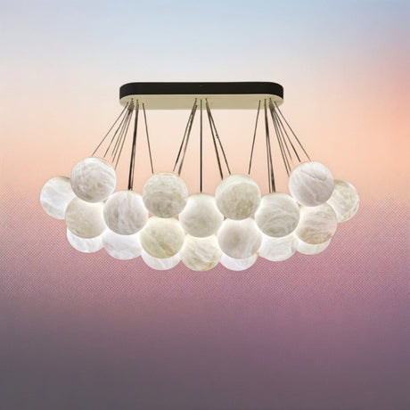 The lit globes packed in two layers, warm light through the veined stone